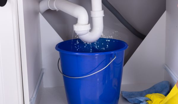 Place a bucket underneath the sink